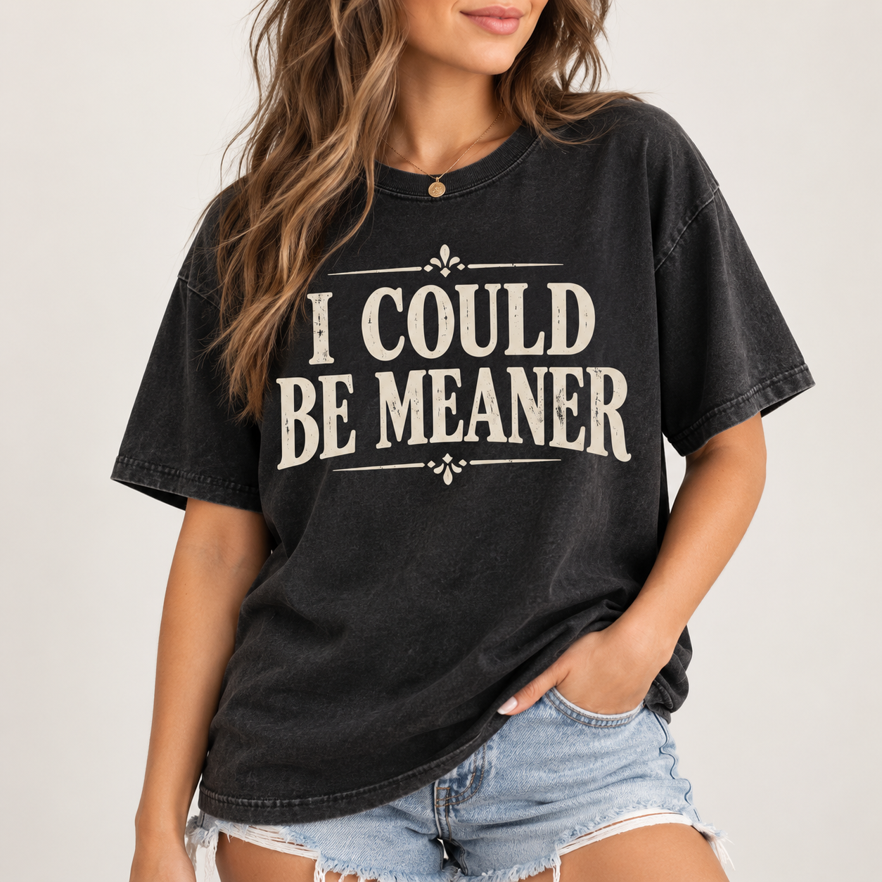 Woman wearing the I Could Be Meaner T-shirt in vintage black