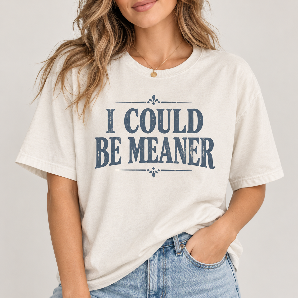 Woman wearing the I Could Be Meaner T-shirt in soft ivory